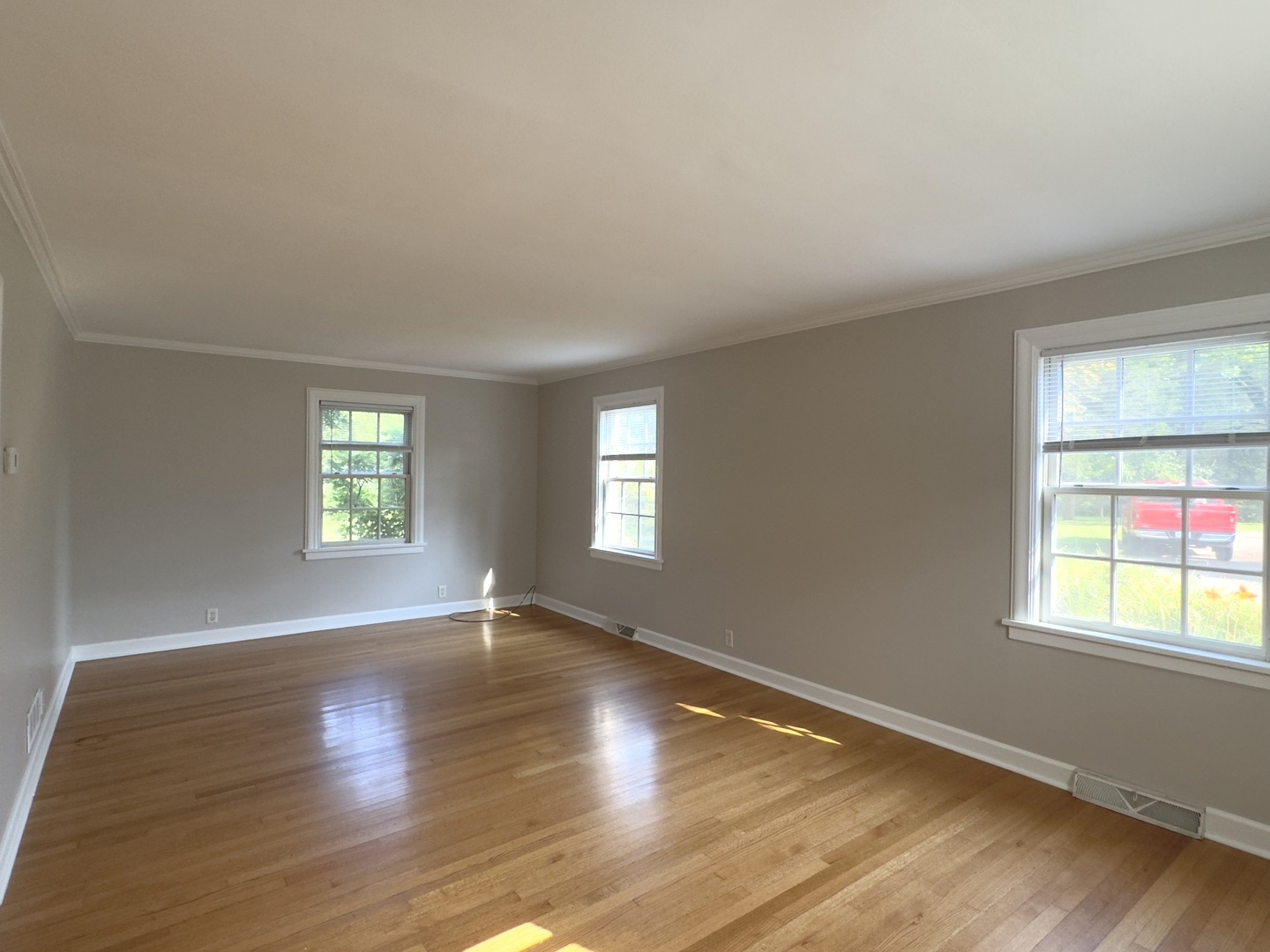 15751 Burr Oak Road Plano, IL 60545 - Photo 4 of 7 an empty room with wooden floor and windows