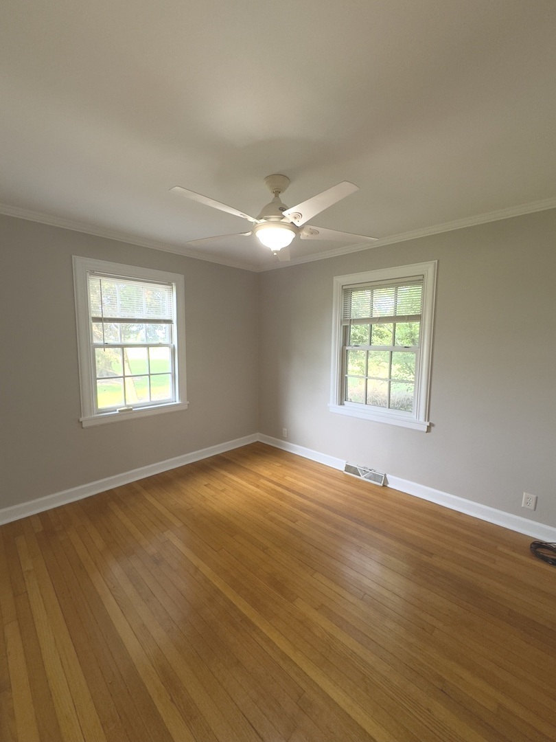 15751 Burr Oak Road Plano, IL 60545 - Photo 5 of 7 an empty room with wooden floor and windows