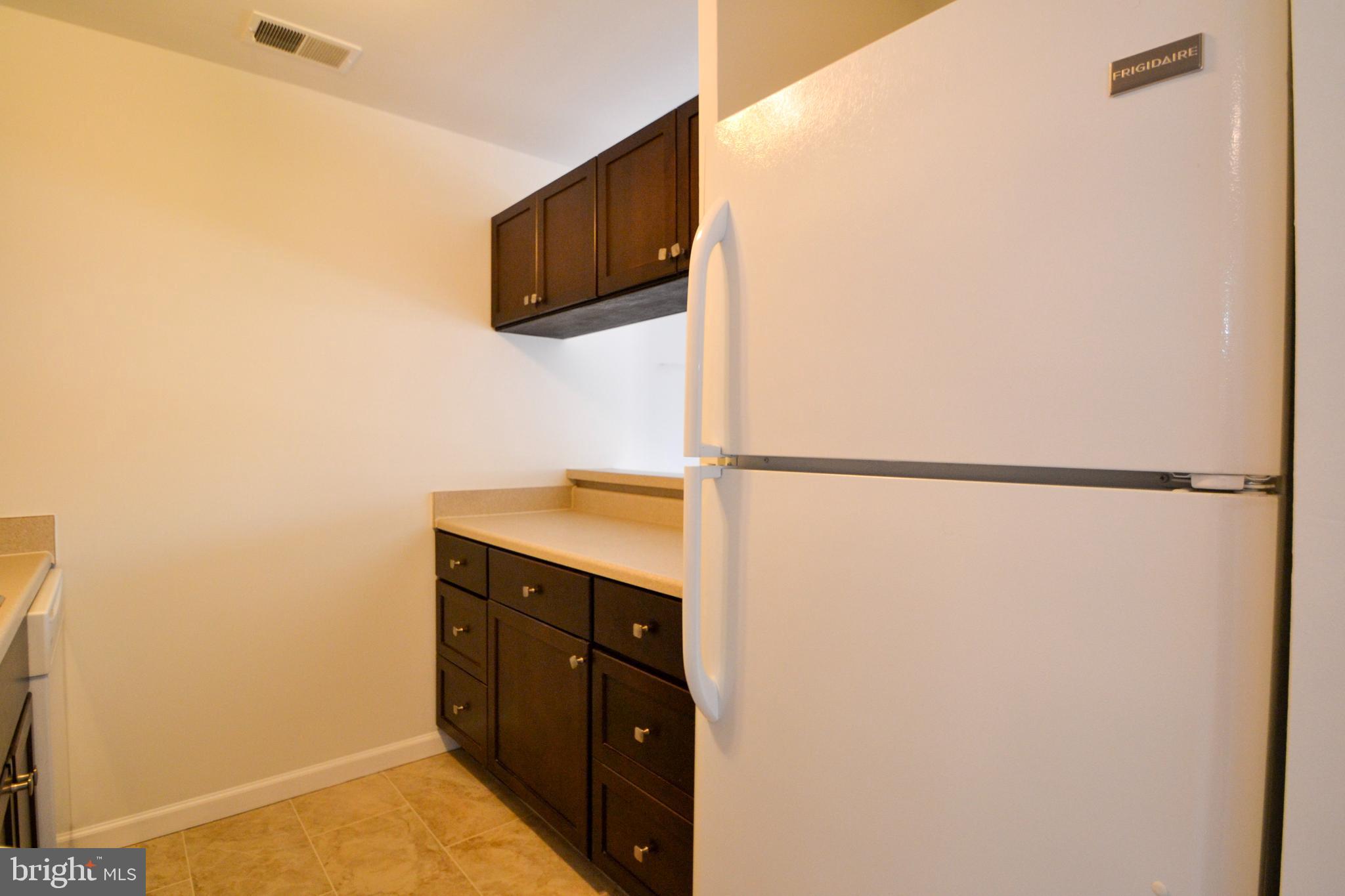 421 South Sharp Street, Unit R 11 Baltimore, MD 21201 - Photo 12 of 26 a kitchen with a sink and a refrigerator
