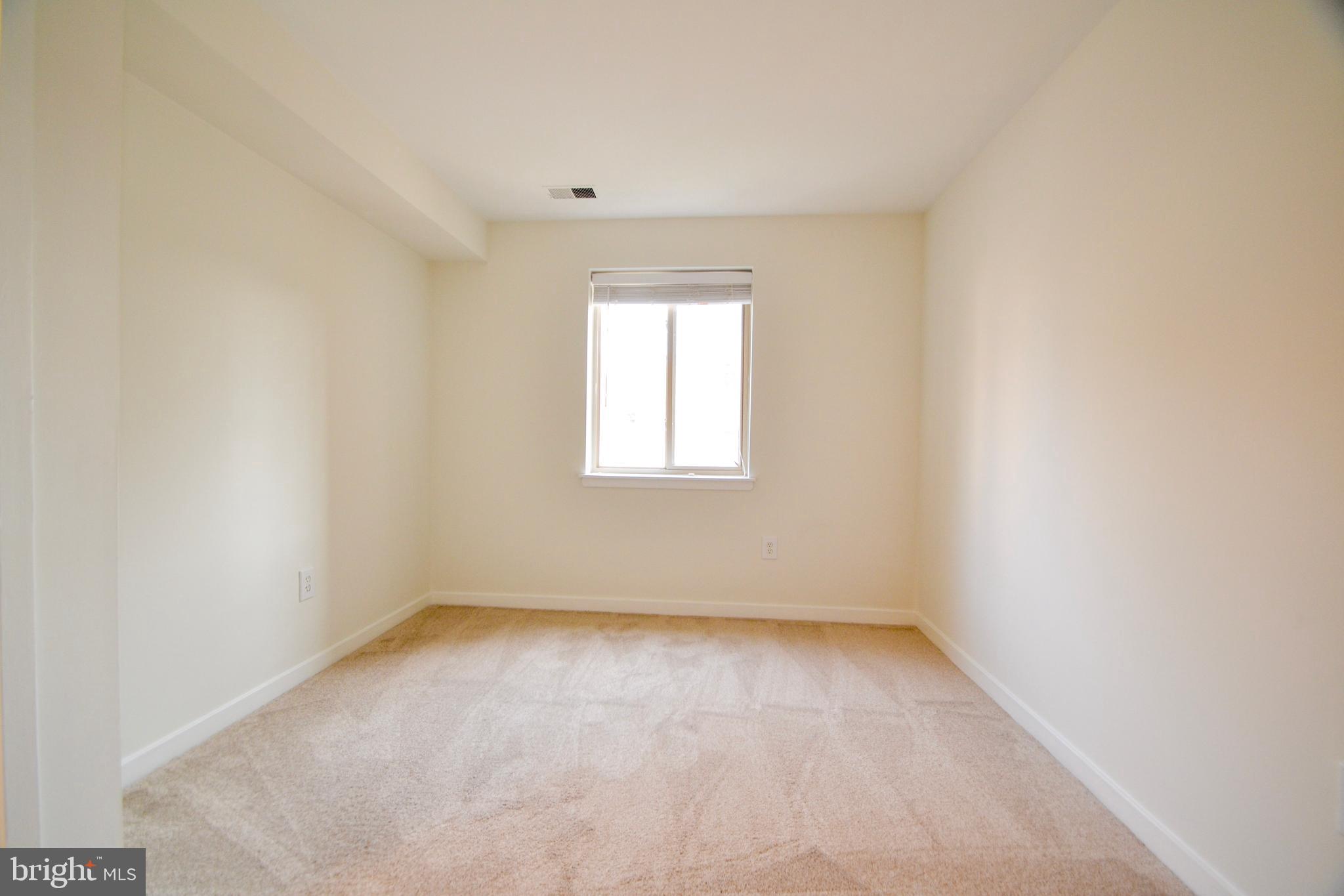 421 South Sharp Street, Unit R 11 Baltimore, MD 21201 - Photo 21 of 26 an empty room with a window