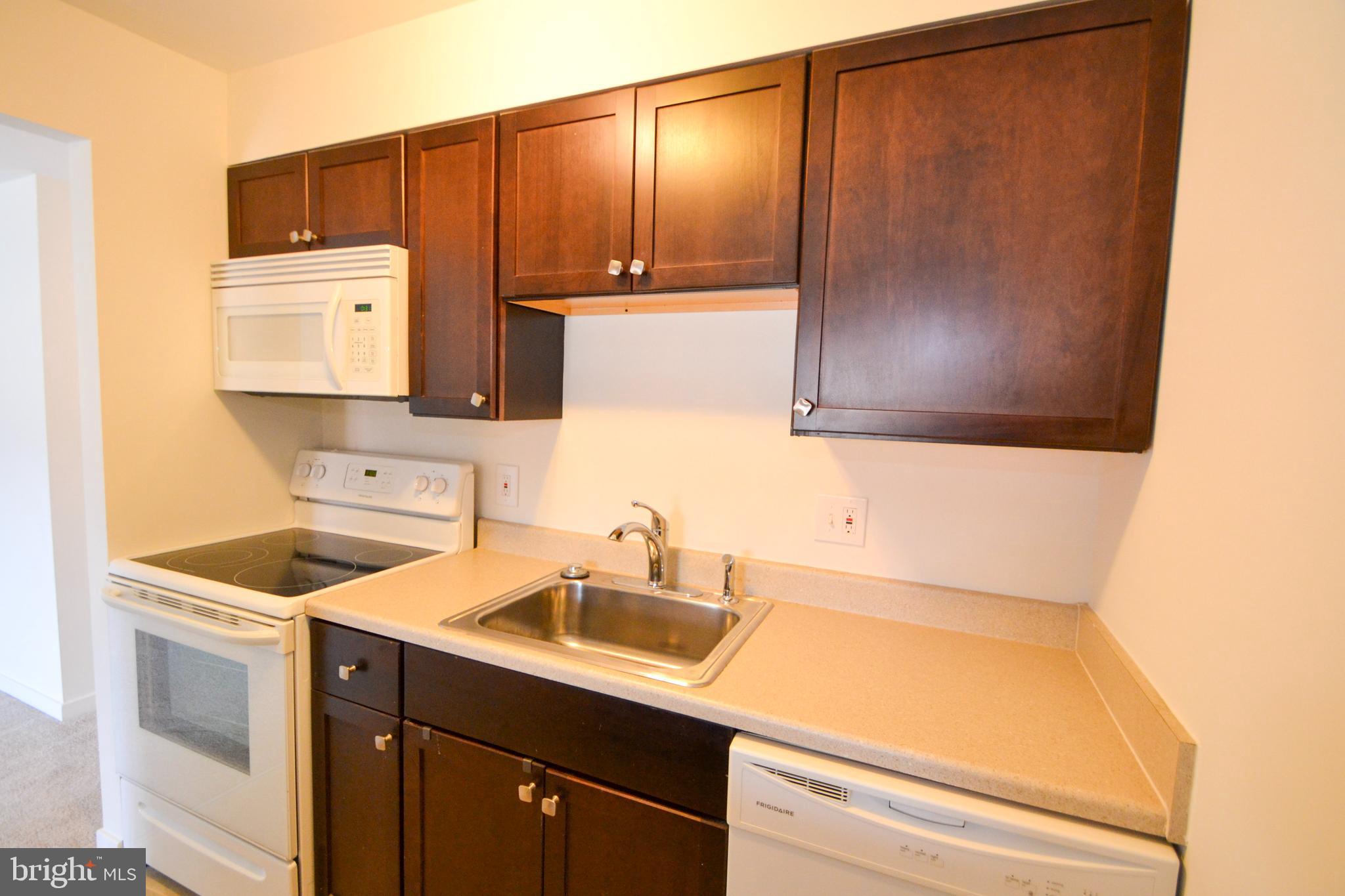 421 South Sharp Street, Unit R 11 Baltimore, MD 21201 - Photo 10 of 26 a kitchen with a sink and cabinets