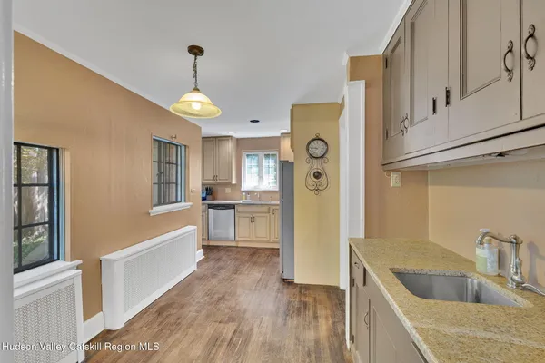a kitchen with a refrigerator a sink and cabinets