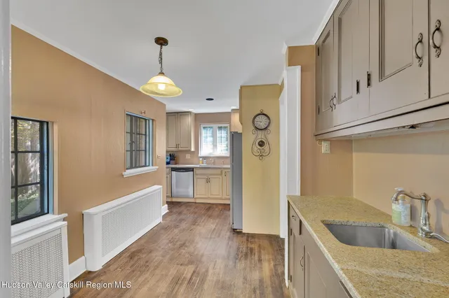 a kitchen with a refrigerator a sink and cabinets