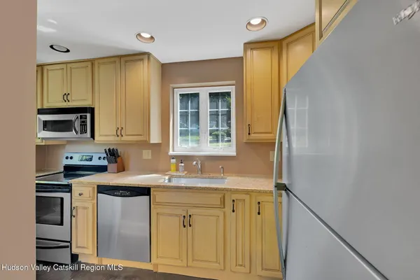 a kitchen with stainless steel appliances granite countertop a sink and a stove
