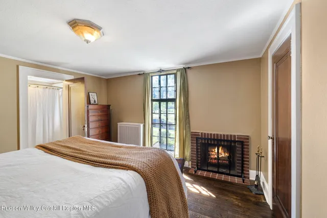a bedroom with a bed and a fireplace