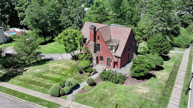an aerial view of a house with a yard and garden