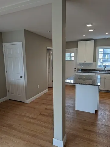 a kitchen with granite countertop a sink and cabinets