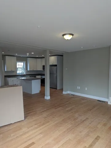 a view of kitchen with kitchen island and stainless steel appliances