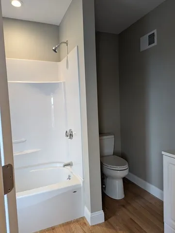 a bathroom with a toilet and a bathtub