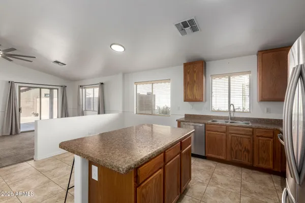 a kitchen with center island table and chairs