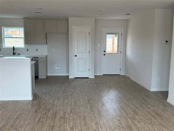 a view of a kitchen with wooden floor and a sink