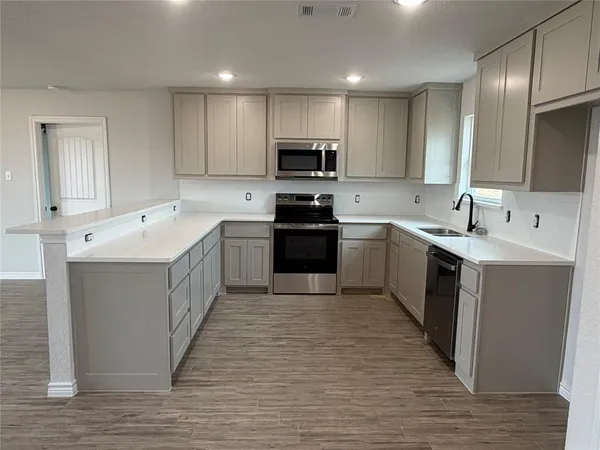 a kitchen with a sink cabinets and stainless steel appliances
