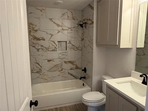 a bathroom with a sink a toilet and a bathtub