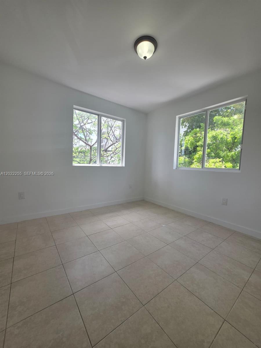 829 Southwest 3rd Street, Unit 831 Miami, FL 33130 - Photo 10 of 21 an empty room with windows