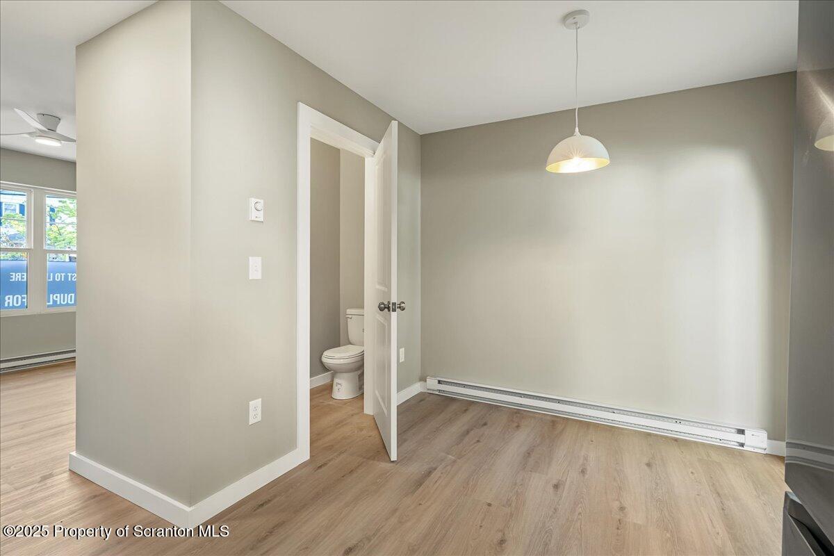 820 822 Delaware Street Scranton, PA 18509 - Photo 13 of 48 an empty room with wooden floor and windows