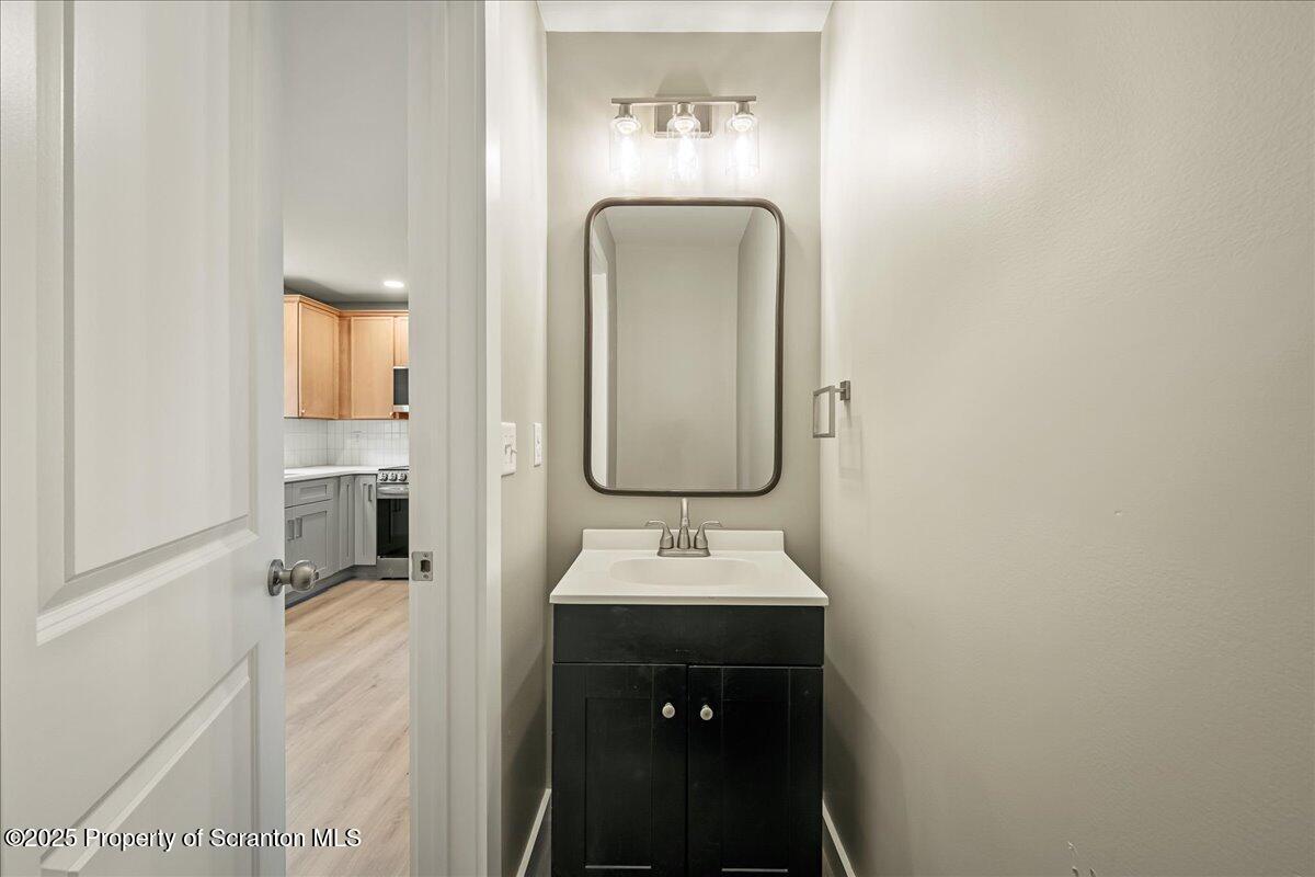 820 822 Delaware Street Scranton, PA 18509 - Photo 14 of 48 a bathroom with a sink and a mirror