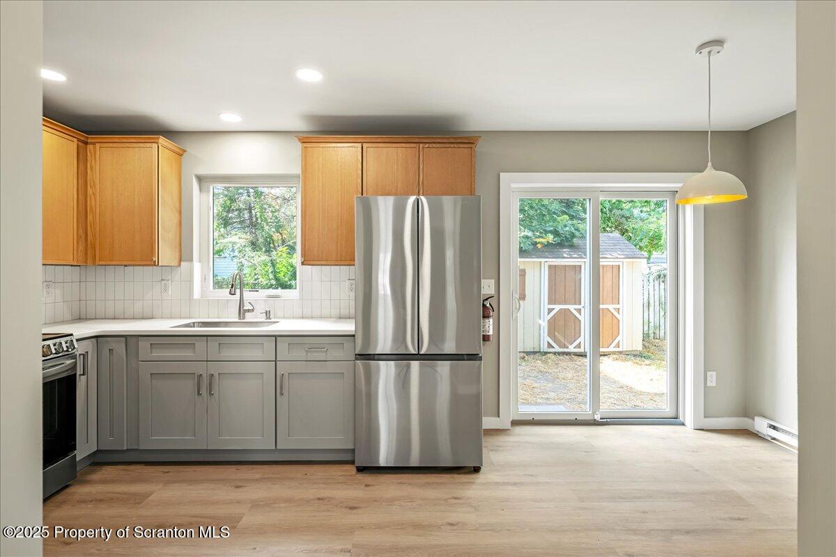 820 822 Delaware Street Scranton, PA 18509 - Photo 17 of 48 a kitchen with stainless steel appliances granite countertop a refrigerator and a sink