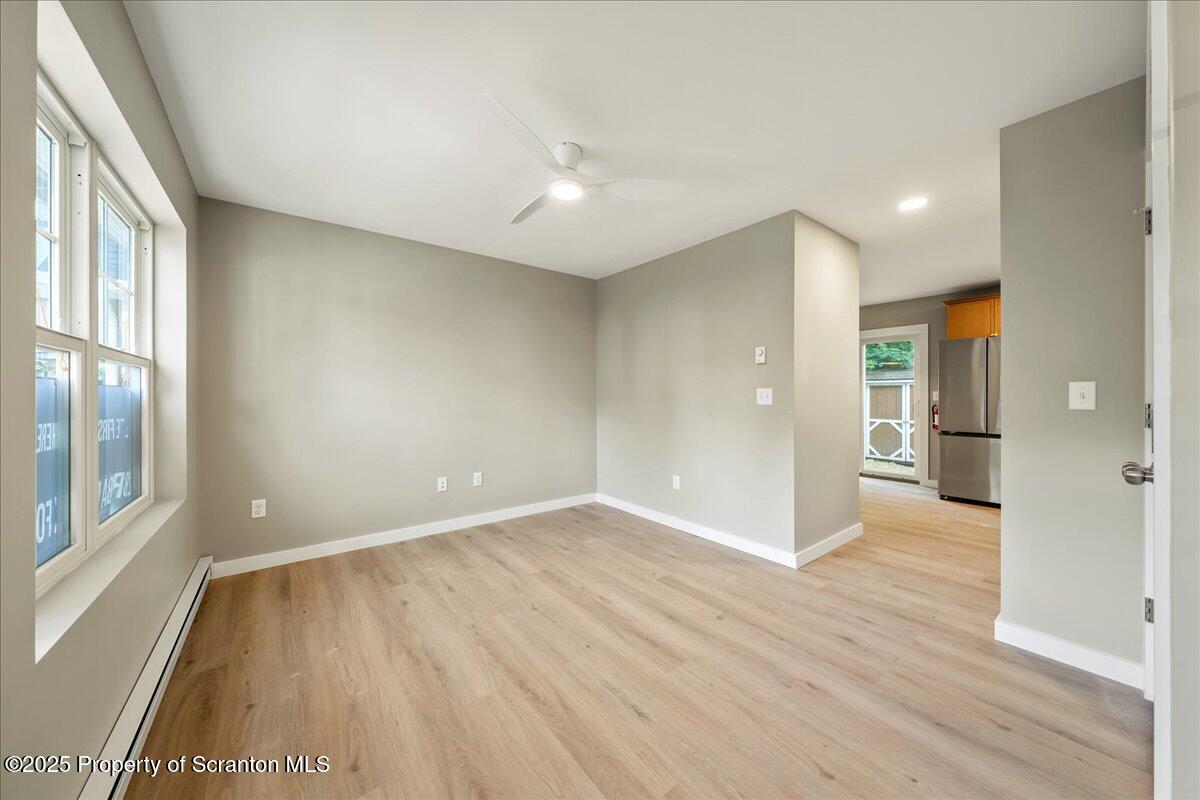 820 822 Delaware Street Scranton, PA 18509 - Photo 22 of 48 a view of an empty room with wooden floor and a window
