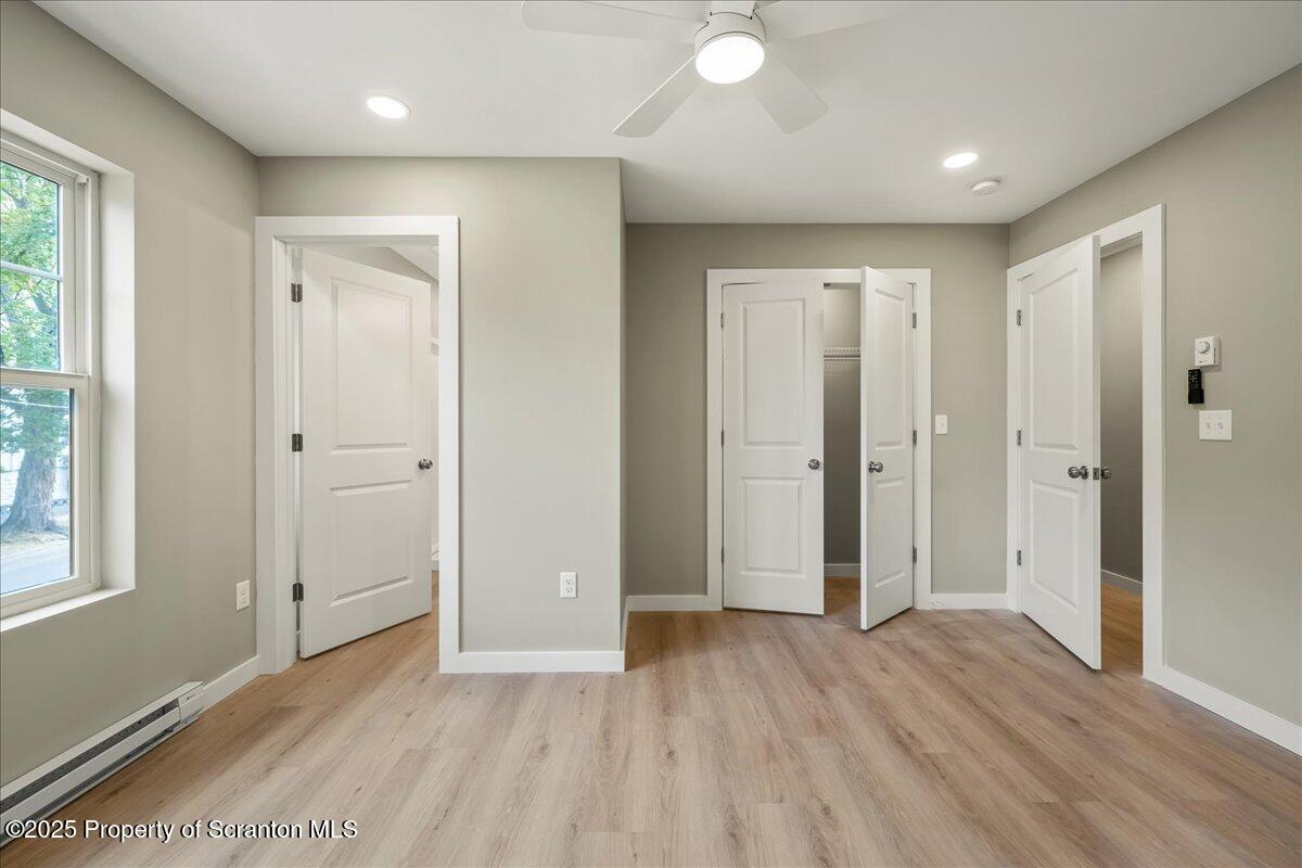 820 822 Delaware Street Scranton, PA 18509 - Photo 23 of 48 a view of an empty room with wooden floor and a window