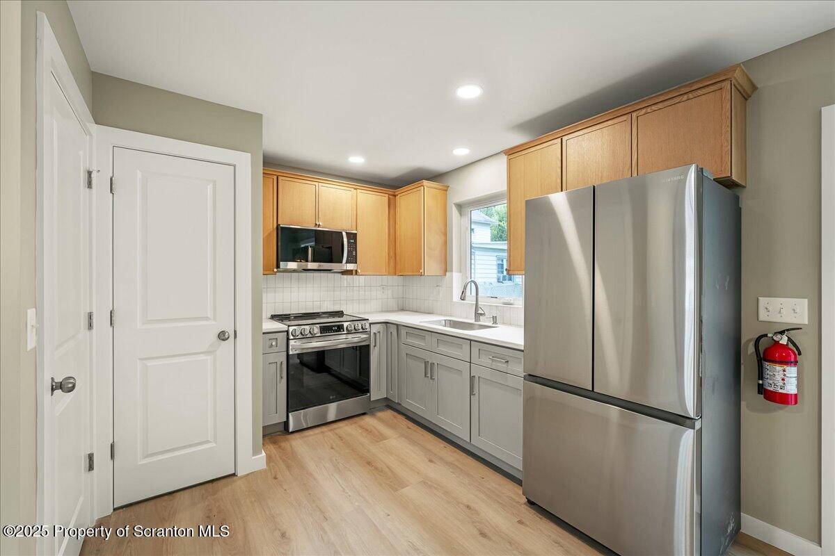 820 822 Delaware Street Scranton, PA 18509 - Photo 3 of 48 a kitchen with stainless steel appliances granite countertop a refrigerator stove and microwave