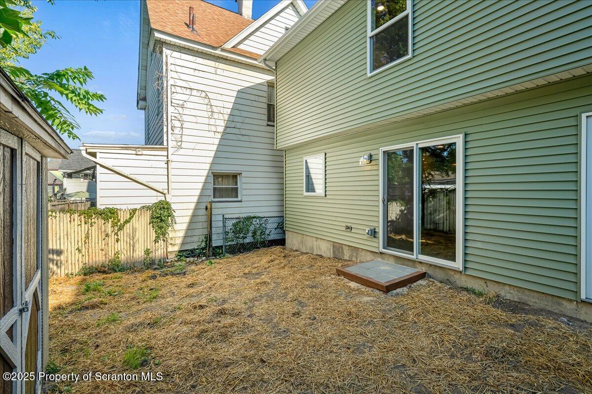 820 822 Delaware Street Scranton, PA 18509 - Photo 36 of 48 a view of a house with a yard and wooden fence