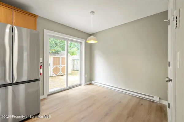 a view of a kitchen with a refrigerator cabinets and a wooden floor