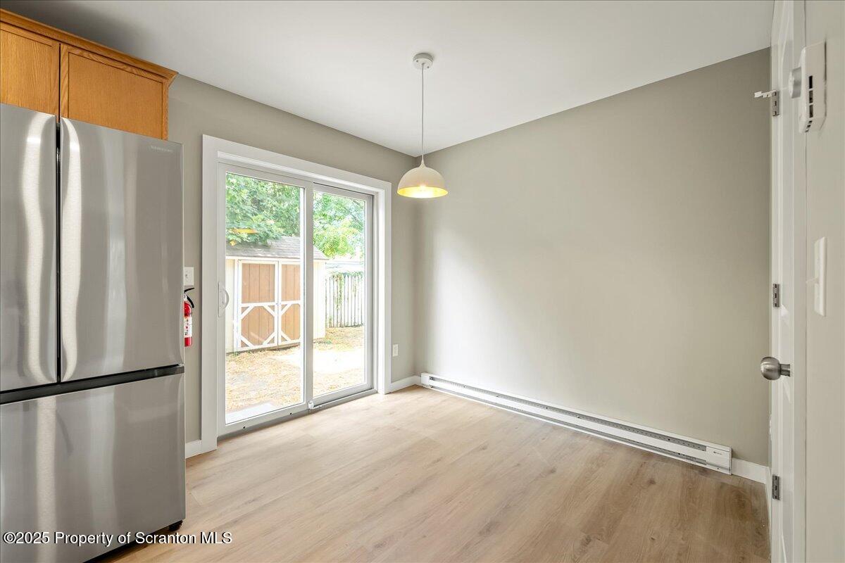 820 822 Delaware Street Scranton, PA 18509 - Photo 8 of 48 a view of a kitchen with a refrigerator cabinets and a wooden floor
