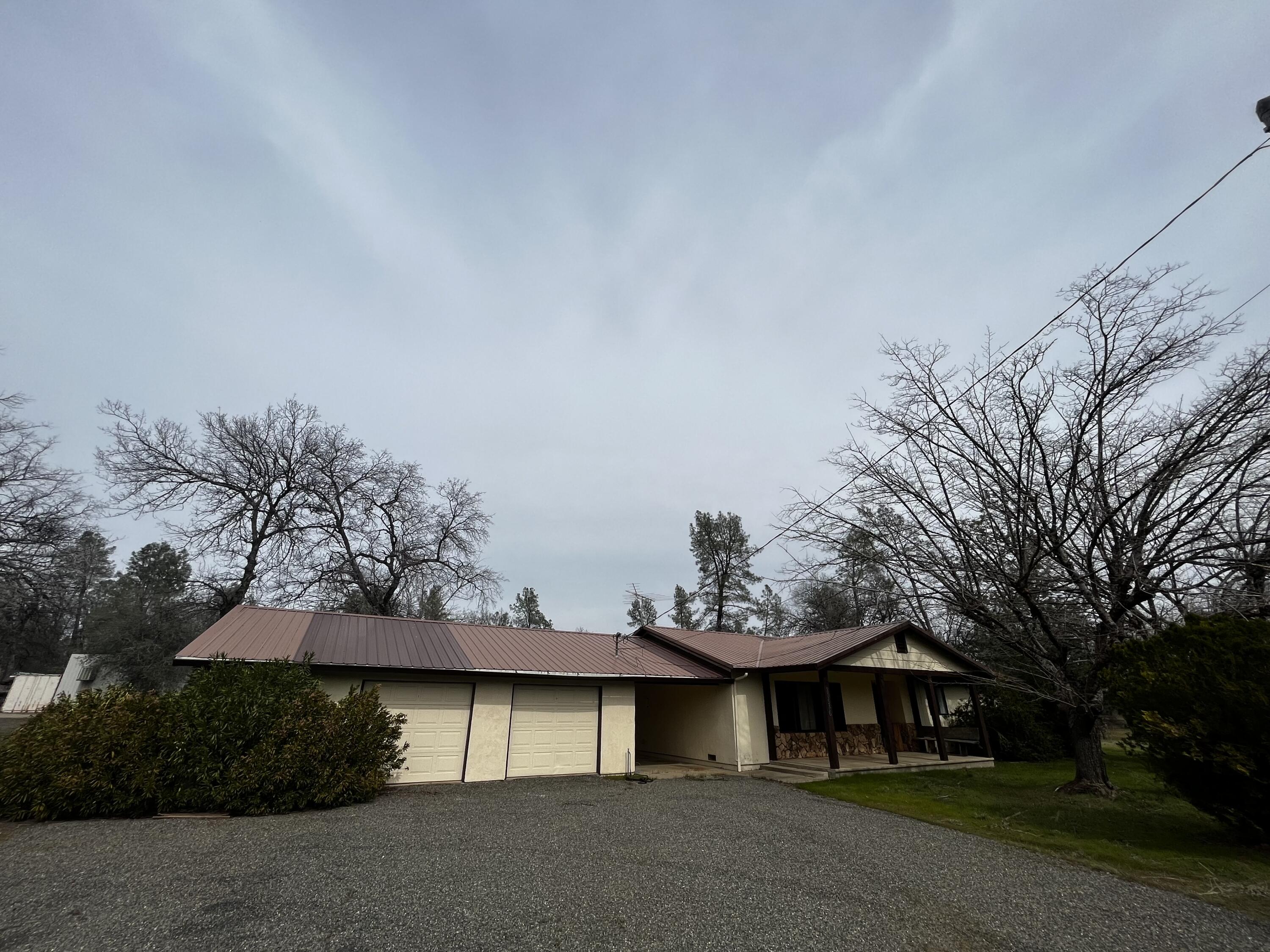 20546 Winchester Trail Redding, CA 96003 - Photo 1 of 1 a view of a house with a yard and garage