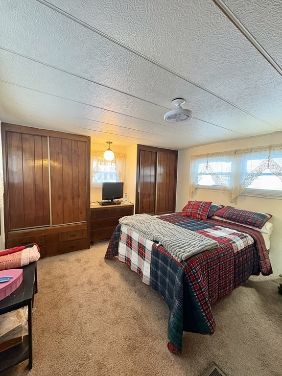 9 King Drive Wareham, MA 02576 - Photo 11 of 12 a spacious bedroom with a bed and window