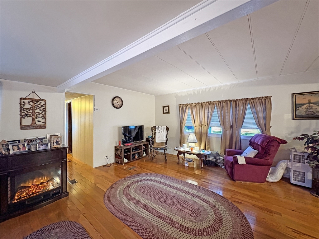 9 King Drive Wareham, MA 02576 - Photo 2 of 12 a living room with furniture fireplace and window