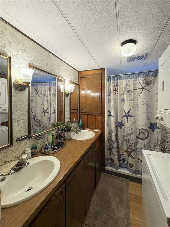 9 King Drive Wareham, MA 02576 - Photo 10 of 12 a bathroom with a double vanity sink mirror and shower