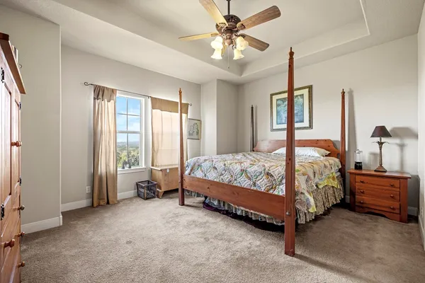 a bedroom with a bed and a chandelier
