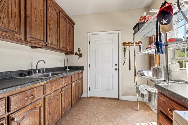 a kitchen with stainless steel appliances granite countertop a sink dishwasher stove and cabinets with wooden floor