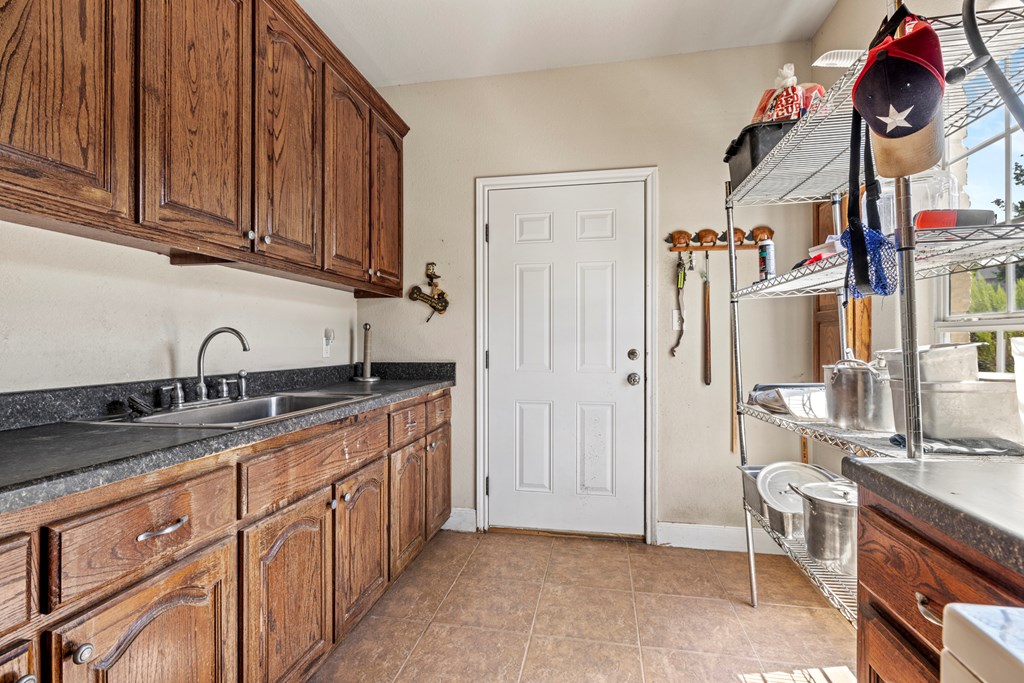 2250 Otte Road Stonewall, TX 78671 - Photo 14 of 35 a kitchen with stainless steel appliances granite countertop a sink dishwasher stove and cabinets with wooden floor