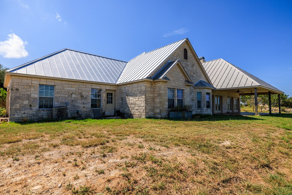 2250 Otte Road Stonewall, TX 78671 - Photo 15 of 35 a front view of a house with a garden