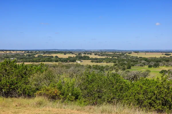 a view of a field with an ocean
