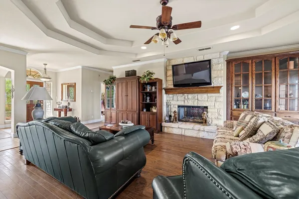 a living room with furniture a flat screen tv and a fireplace
