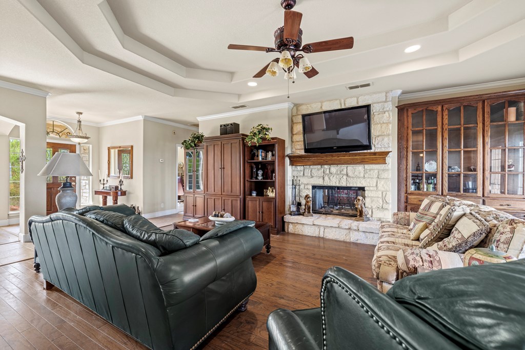 2250 Otte Road Stonewall, TX 78671 - Photo 4 of 35 a living room with furniture a flat screen tv and a fireplace