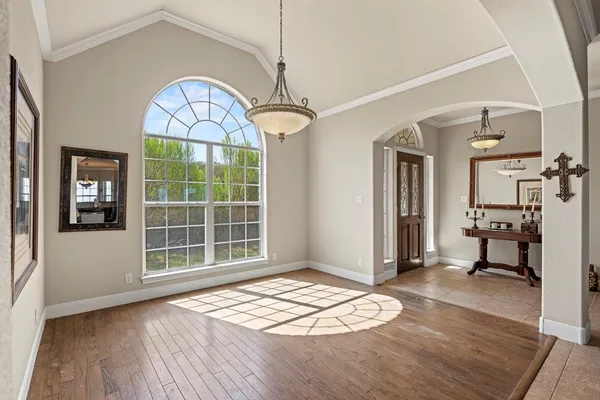 a view of a livingroom with wooden floor and a window