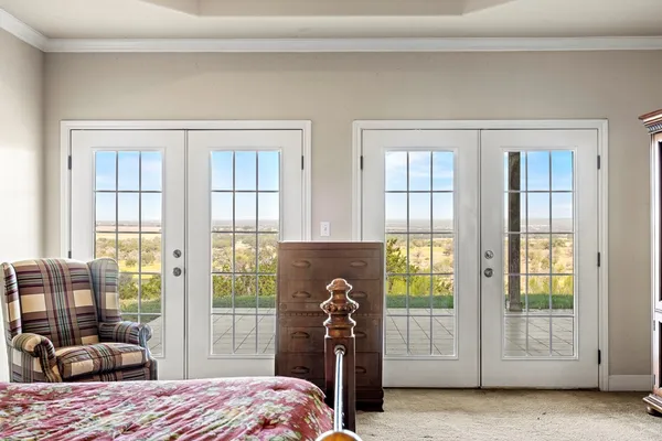 a bedroom with a bed and a large window