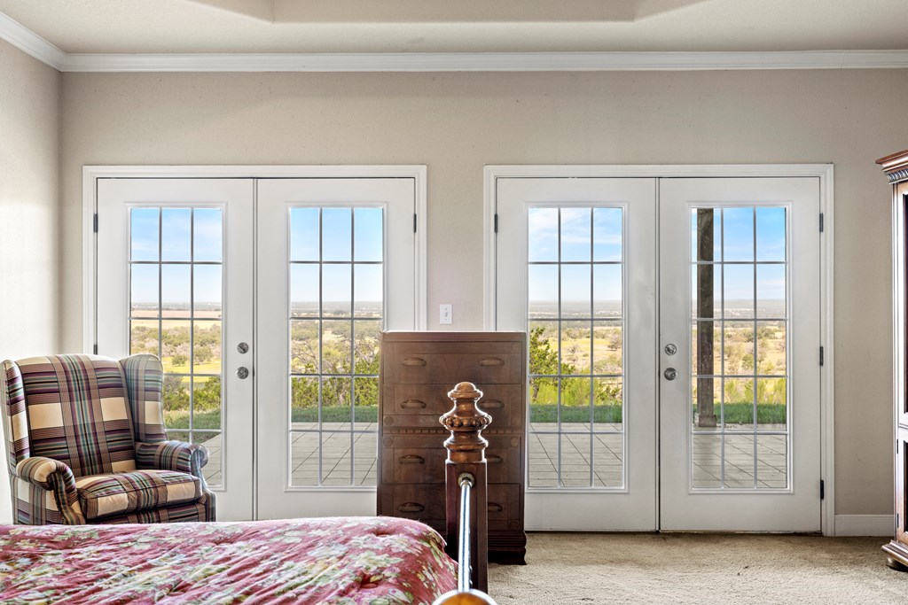 2250 Otte Road Stonewall, TX 78671 - Photo 9 of 35 a bedroom with a bed and a large window