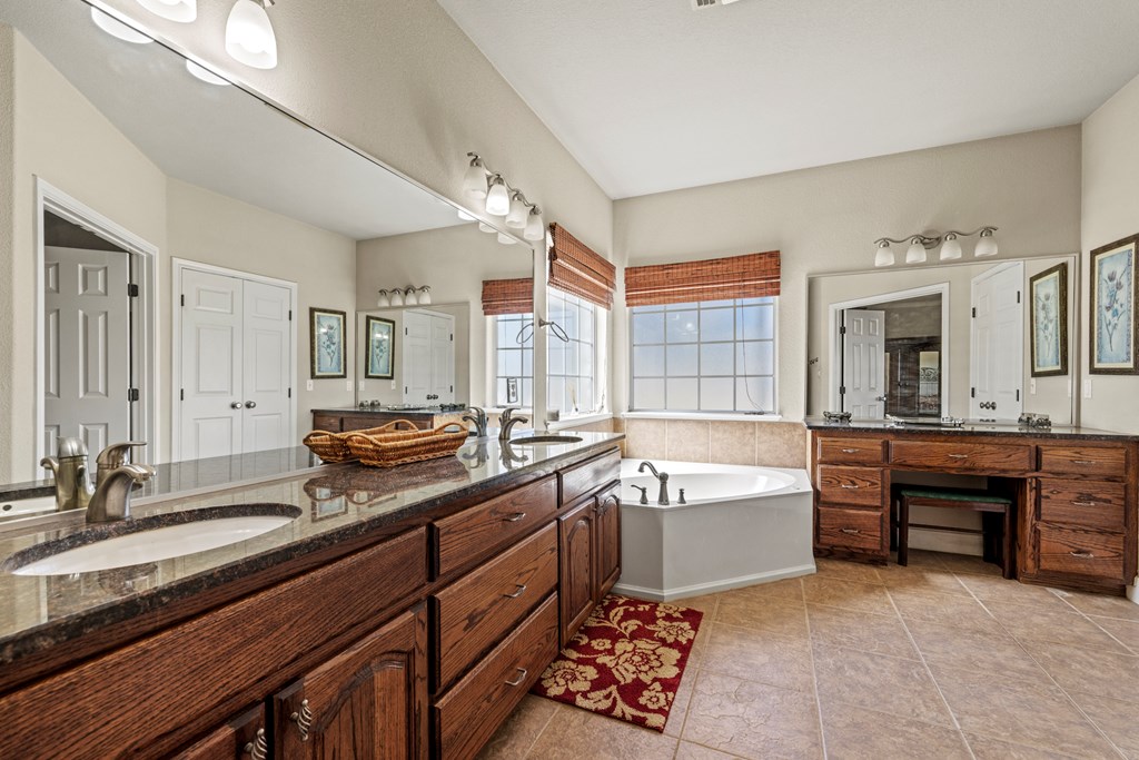 2250 Otte Road Stonewall, TX 78671 - Photo 10 of 35 a spacious bathroom with a tub double sink and mirror