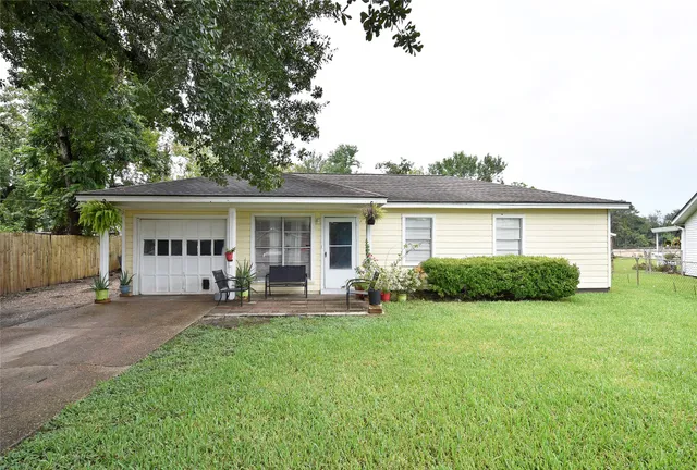 a front view of house with a garden and sitting area