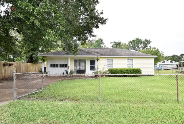 a view of a house with a yard and sitting area