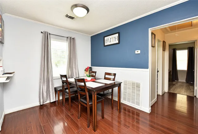 a view of a dining room with furniture and wooden floor