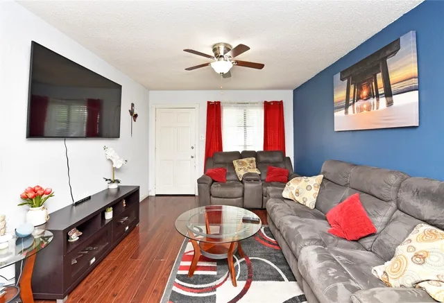a living room with furniture and a flat screen tv