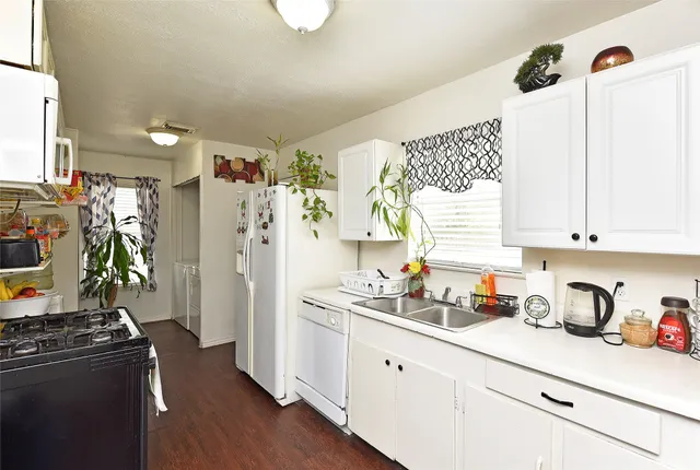 a kitchen with stainless steel appliances granite countertop a refrigerator and a stove