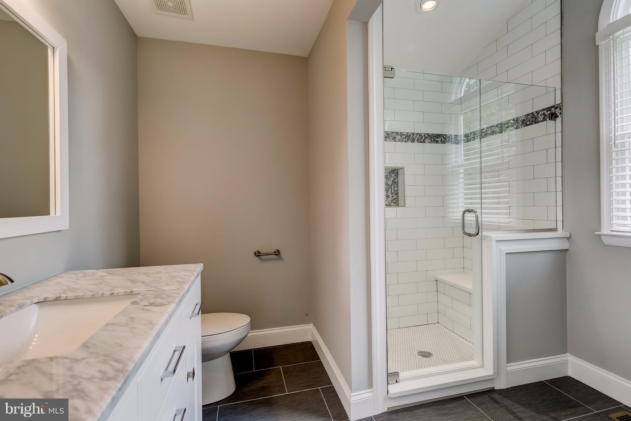 625 Edwards Road Annapolis, MD 21409 - Photo 11 of 30 a bathroom with a granite countertop sink a toilet and shower