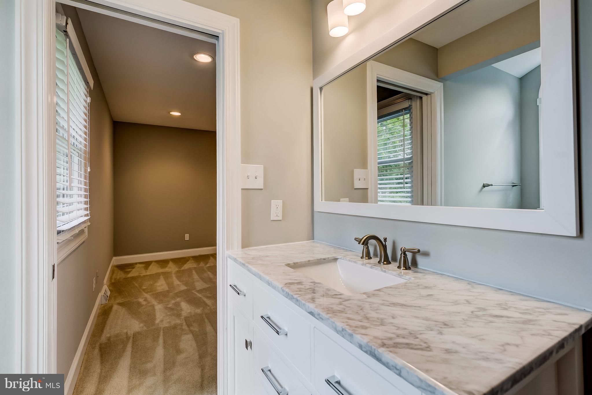 625 Edwards Road Annapolis, MD 21409 - Photo 13 of 30 a bathroom with a granite countertop sink and a mirror