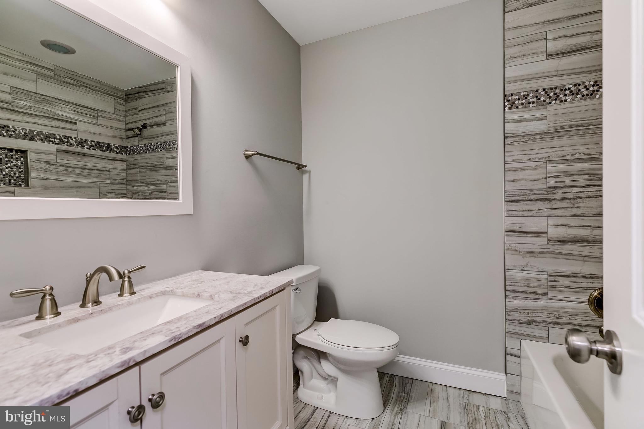 625 Edwards Road Annapolis, MD 21409 - Photo 26 of 30 a bathroom with a granite countertop toilet sink and mirror